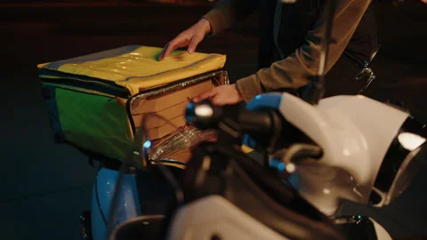 The courier takes out pizza boxes from a thermos bag Stock Footage 214873616