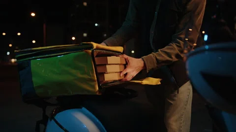 The courier takes out pizza boxes from a thermos bag Stock Footage 233980112