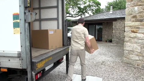 Courier takes a parcel out of the back of a truck. House / home delivery. Stock Footage 125133202