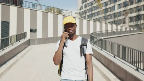 The courier talks on the phone and takes orders. Fast delivery of various goods Stock Footage 172297582