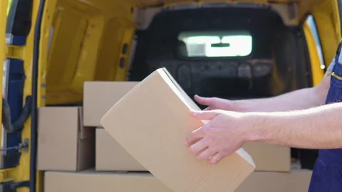 The courier throws the parcel standing near delivery van Stock Footage 193438957
