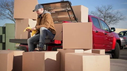 Courier Unloading Shipping Boxes Parcel From His Truck 库存影片 166658804