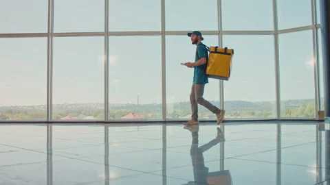 Courier On the Way to Deliver Order to a Client. Panoramic Window View Stock-Footage 211877456