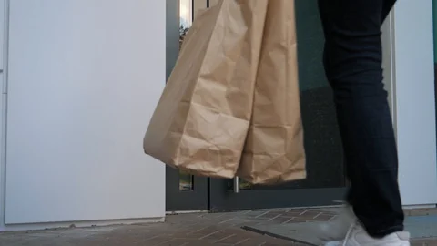 Courier Wearing Gloves Performs Contactless Delivery Of Food To Customers Door Video stock 129730688
