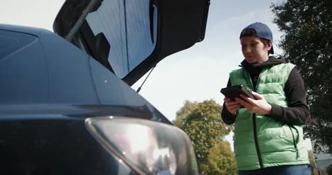 Courier works stacks boxes in a car. Fast and safe delivery concept. Stock Footage 140609233