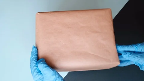 Courier's hands in protective gloves moving parcel and showing thumbs up. 스톡 동영상 130128276