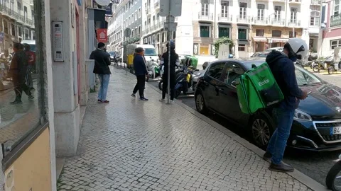 Couriers waiting for orders to drop in front of a restaurant at Stock Footage 186667788