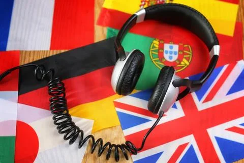 Course language headphone and flag on a table Stock Photos