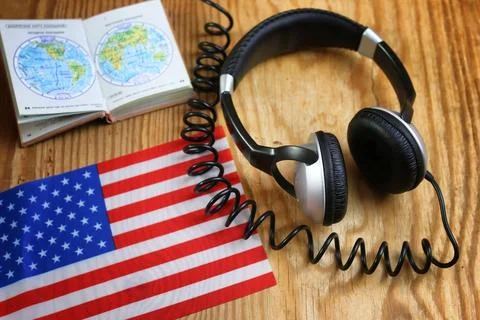Course language headphone and flag on a table Stock Photos