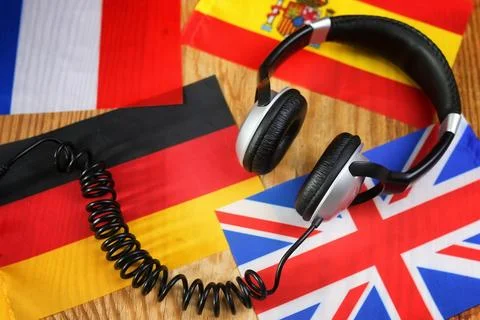 Course language headphone and flag on a table Stock Photos