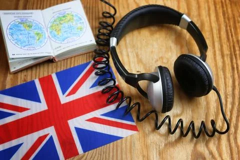 Course language headphone and flag on a table Stock Photos