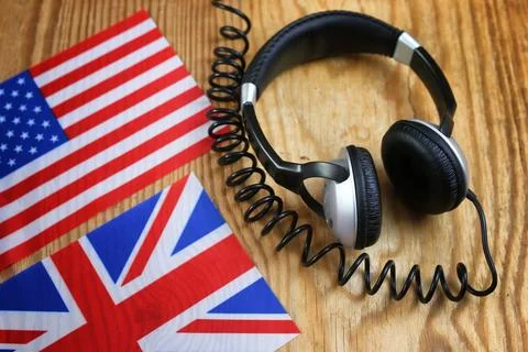 Course language headphone and flag on a table Stock Photos