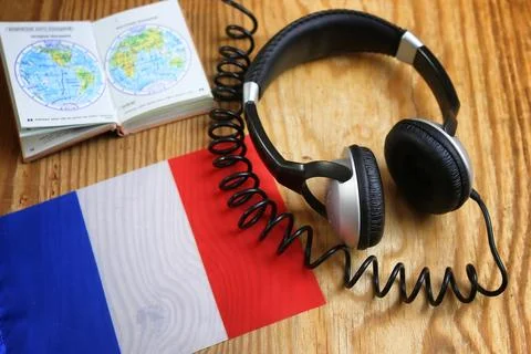 Course language headphone and flag on a table Stock Photos