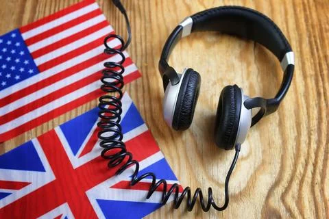 Course language headphone and flag on a table Stock Photos