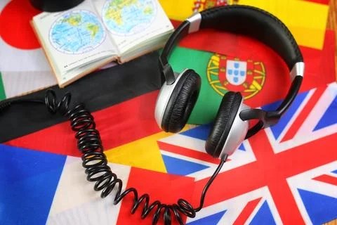 Course language headphone and flag on a table Stock Photos
