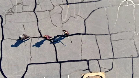 In course of worker patching patcher performs coated crack filling asphalt crack Stock Footage 276138846