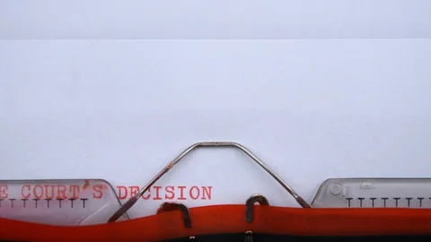 The court's decision - phrase printed on an old typewriter in red letters Stock Footage 128400704