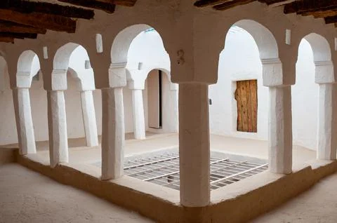 Courtyard with arches, columns, and patterned floor in a traditional buildi.. Stock Photos