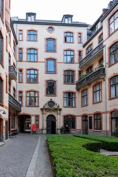 A courtyard with a building in the background Stock Photos
