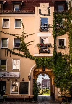 The courtyard of the house with a clock on the facade. Stock Photos