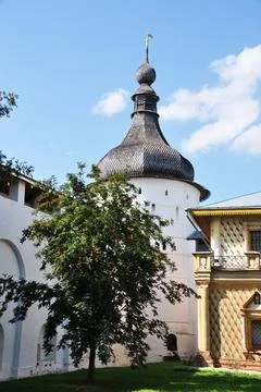 In the courtyard of an old monastery. View of the corner tower and wall. Stock Photos