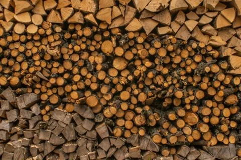 In the courtyard is a stack of firewood of different shapes Stock Photos