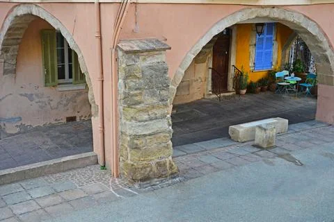 Courtyard under an arch in a gallery Stock Photos