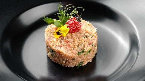 Cous-cous on a black plate Stock Photos