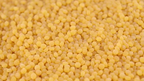 Couscous grains shifting on flat surface in close up macro Stock Footage 331462174