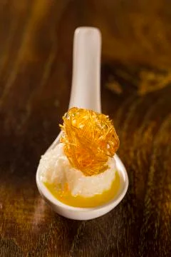 Couscous of tapioca with coconut, physalis, caramel yarns and burnt coconut.. Stock Photos