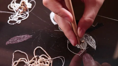 Couture embroidery using Luneville hook (crochet). Chain stitch Stock Footage 146258900
