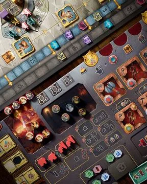 Covenant board game components close up featuring player board building til.. Stock Photos