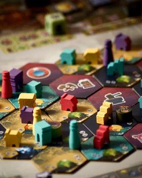 Covenant board game components close up featuring player board building til.. Stock Photos
