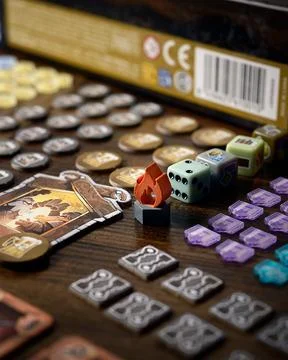 Covenant board game components close up featuring player board building til.. Stock Photos