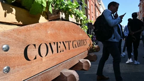 A Covent Garden sign with people standing in the background Stock Footage 159233953