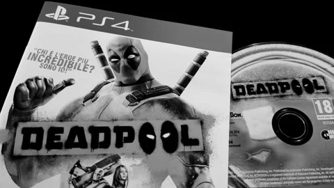 The cover and Blu-ray Disc of Deadpool, for PS4. Stock Footage 282015910