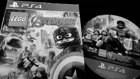 The cover and Blu-ray Disc of the game Lego Marvel Avengers - PS4 Stock Footage 283681045