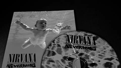 The cover and CD of Nevermind, by the American band Nirvana Stock Footage 296995345