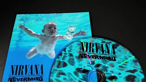 The cover and CD of Nevermind, by the American band Nirvana Stock Footage 296995346