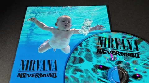 The cover and CD of Nevermind, by the American band Nirvana Stock Footage 296995351