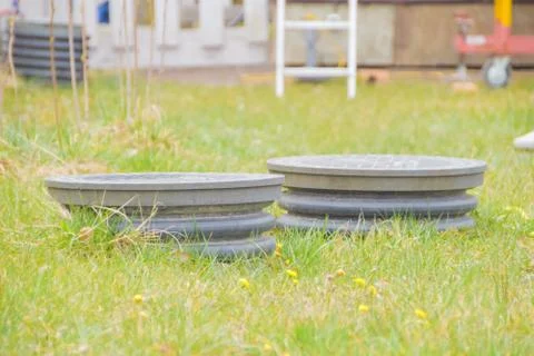 Cover sewer in the grass on the garden plot Stock Photos