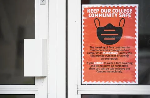Cover your face using a mask sign at school college door Stock Photos