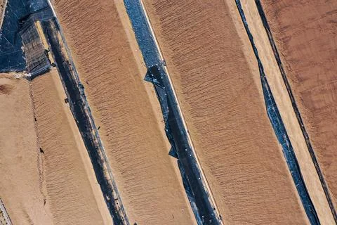 Coverage of clay-type material on geosynthetics in mine fill Stock Photos