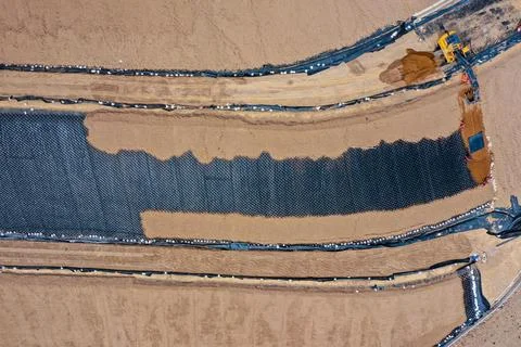 Coverage of clay-type material on geosynthetics in mine fill Stock Photos
