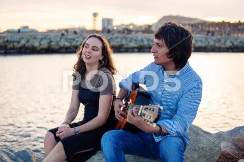 Coverband couple of musicians play acoustic guitar and sing near the beach Stock Photos
