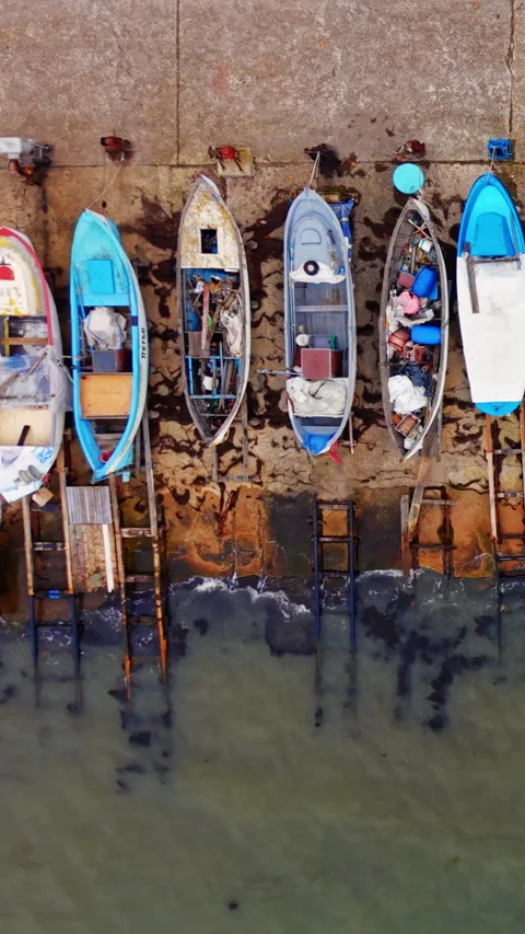 Covered boat and surfboard on stone quay, Nesebar, Bulgaria Vertical video. Stock Footage 338007718
