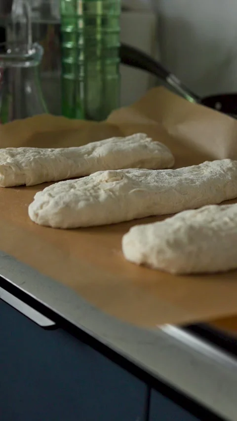 Covered bread dough resting beneath striped cloth on kitchen counter, showing Stock Footage 339306711