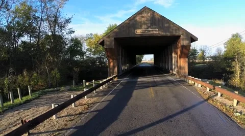 COVERED BRIDGE, AERIAL SHOT, CAMERA MOVES THROUGH BRIDGE Stock Footage 43258221
