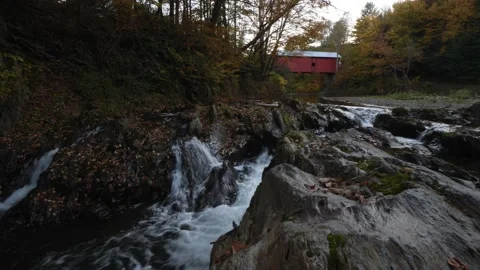A covered bridge and a creek during fall in New England Stock Footage 166858876