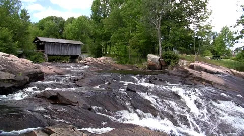 Covered bridge and fast running stream Stock Footage 2923252